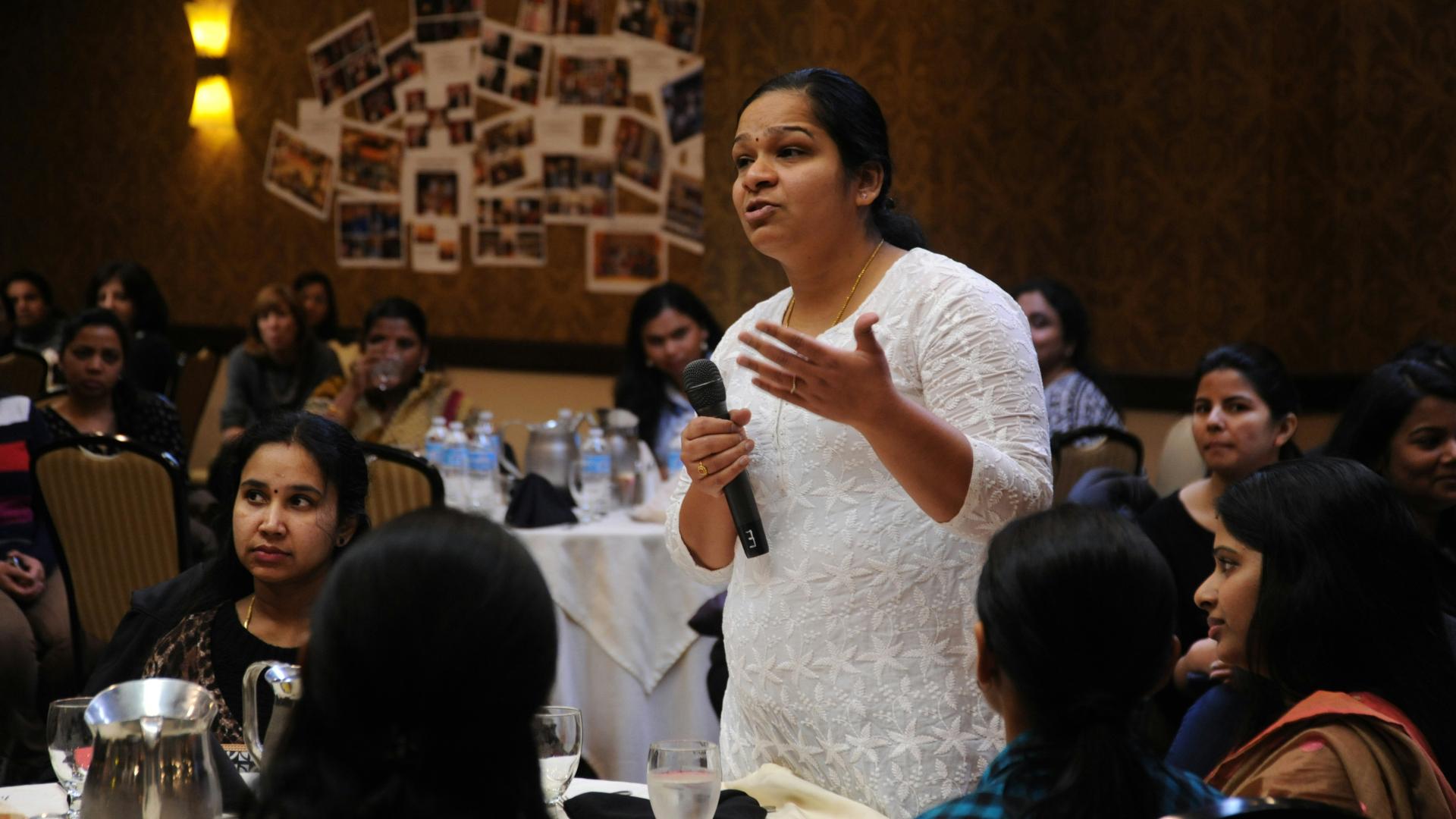 a woman speaking to a group of people