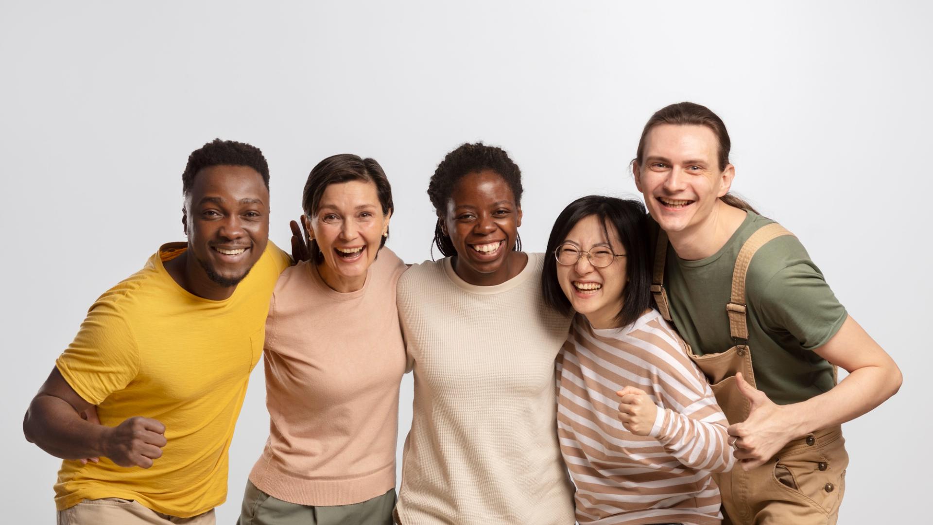 Group photo of five individuals with diverse backgrounds, showing joy.