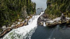 Rushing river between two tree-covered land masses