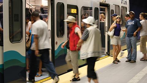 people boarding an LRT train